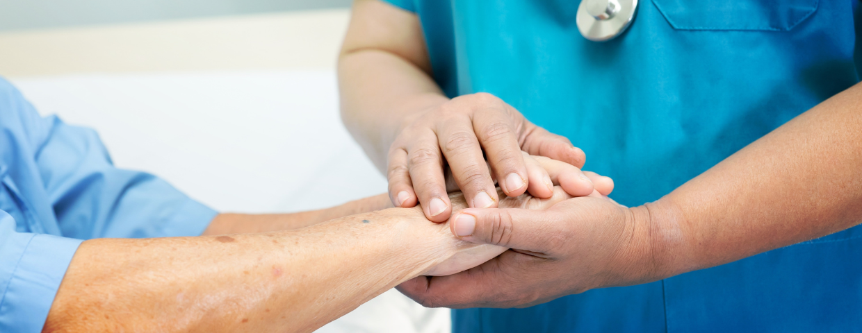 doctor holding hands of a post-surgery patient