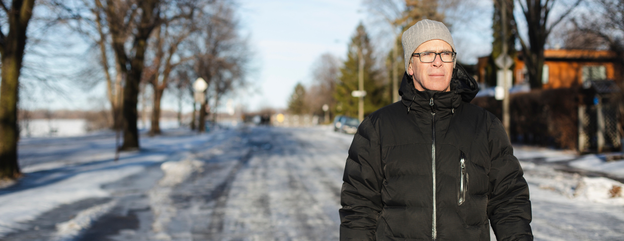 man walking on cold snowy winter street