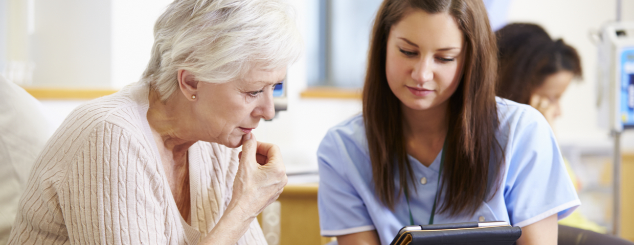 Nurse Shows Tablet to Elderly Patient